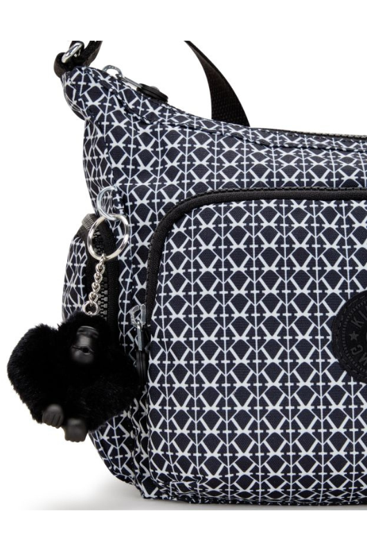 Kipling Gabb S Medium Crossbody Bag. A crossbody bag with adjustable strap, zip closure, multiple compartments, Kipling monkey charm, and all over black and white print.