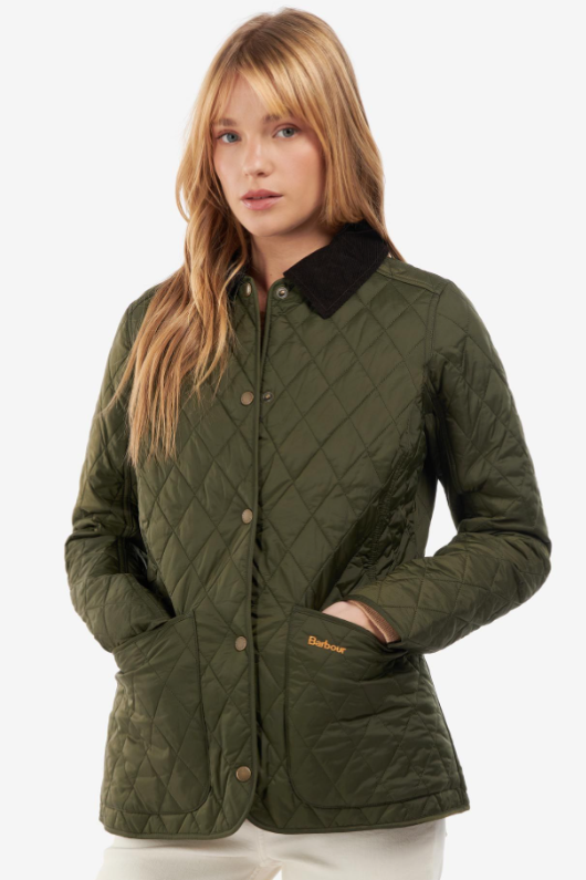 An image of a female model wearing the Barbour Annandale Quilted Jacket in the colour Olive.