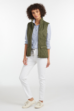 An image of a female model wearing the Barbour Otterburn Gilet in the colour Olive.