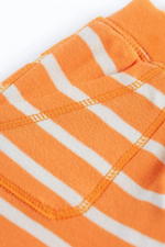 An image of the Frugi Little Ellis Shorts in the colour Tangerine Breton.