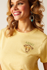 An image of a female model wearing the Ariat Cow Sunset T-Shirt in the colour Jojoba.