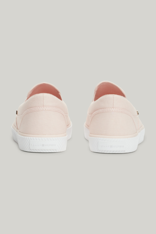 An image of the Tommy Hilfiger Enamel Flag Slip-On Canvas Trainers in the colour Whimsy Pink.