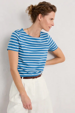 An image of a female model wearing the Seasalt Sailor T-Shirt in the colour Breton Sailboats Chalk.