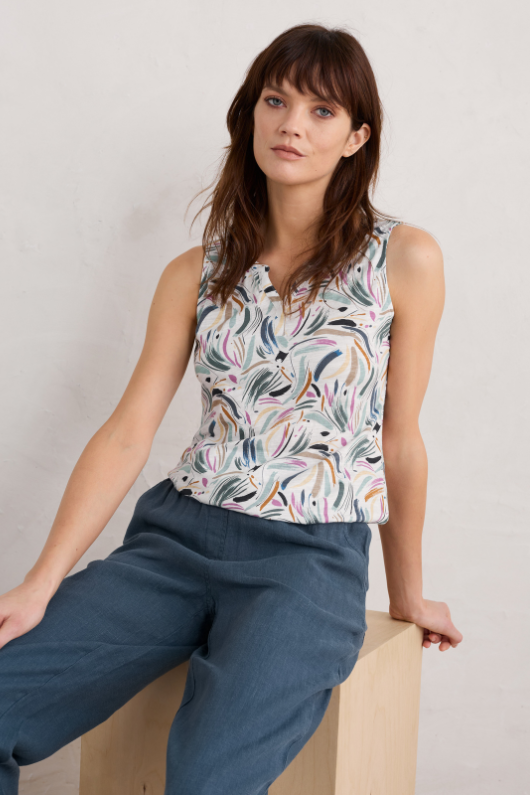 An image of a female model wearing the Seasalt Purist Summer Vest Top in the colour Dune Marks Chalk.
