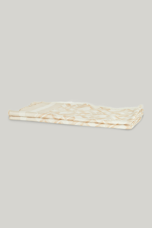 An image of the Tommy Hilfiger TH Monogram Jacquard Scarf in Classic Beige.