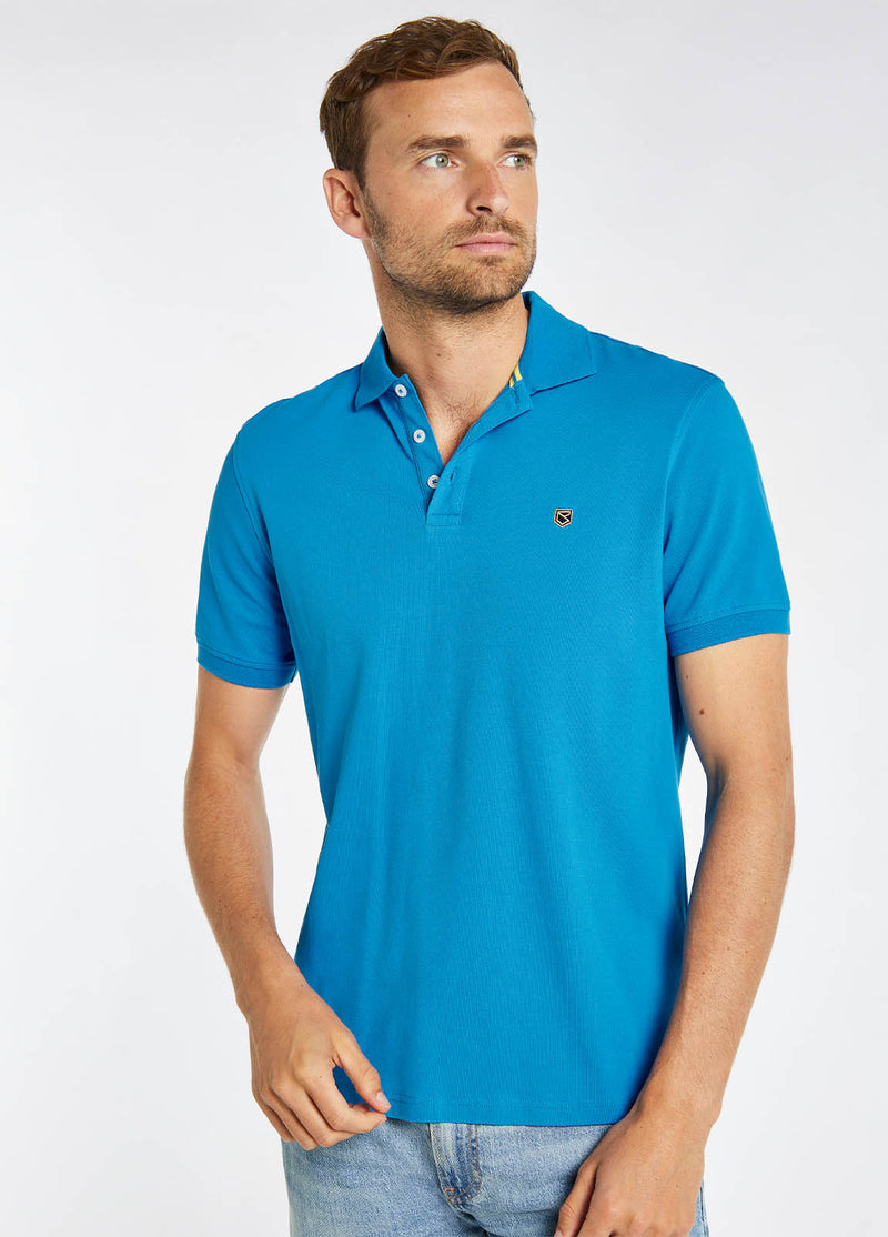 Dubarry Quinlan Polo Shirt. A short sleeve polo with collar, button fastenings, logo embroidery, and anti microbial/UPF 40 finish. Greek Blue.