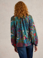 An image of the White Stuff Imogen Top in Green Print.