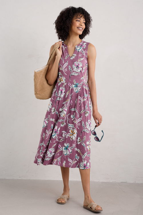 An image of a female model wearing the Seasalt Shelter Bay Sleeveless Jersey Midi Dress in the colour Linework Floral Heather.
