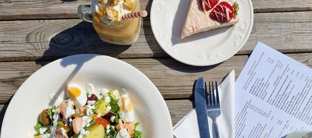 An image of some of the Brodie Countryfare Family Restaurant menu items, including salad, pudding, and iced drinks.