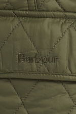 An image of a female model wearing the Barbour Otterburn Gilet in the colour Olive.