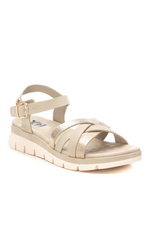 XTI Low Wedge Sandal. A pair of wedge sandals with intertwining metallic gold straps and gold buckle detail.