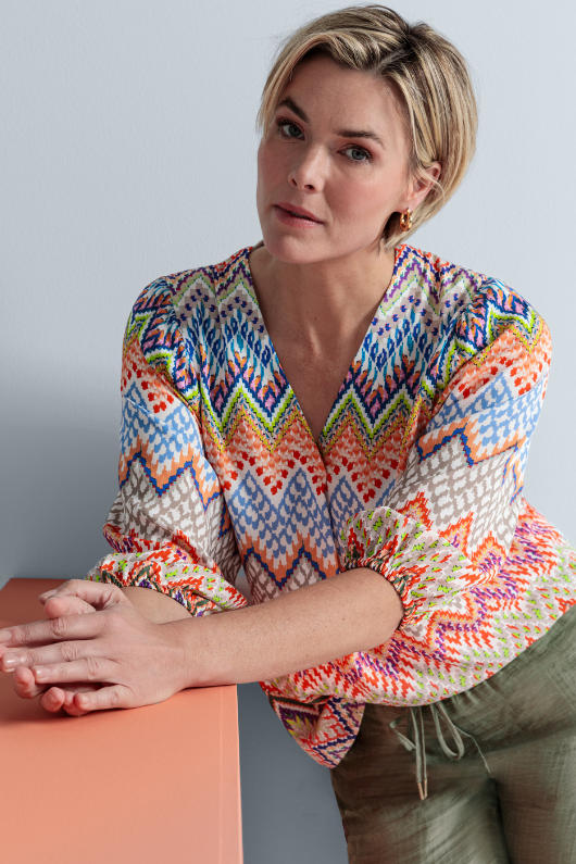 An image of a female model wearing the Bianca Alena Blouse in the colour Multi.