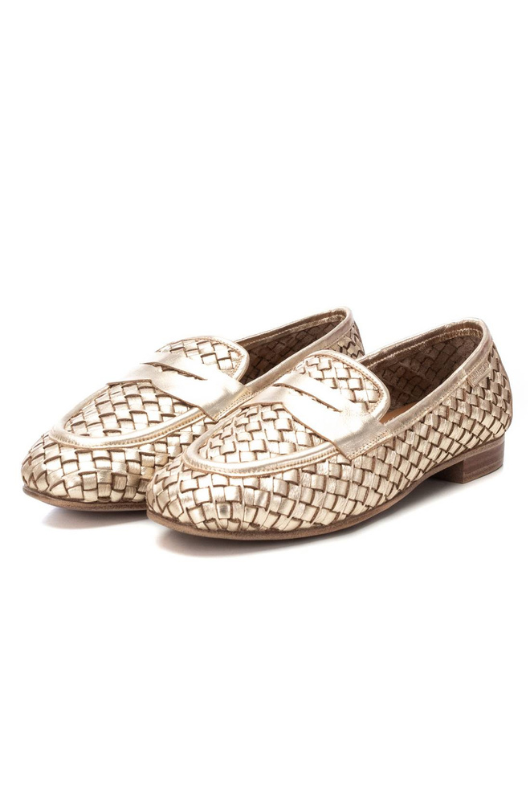 Carmela Loafer. A pair of gold moccasin shoes with interlocking design.