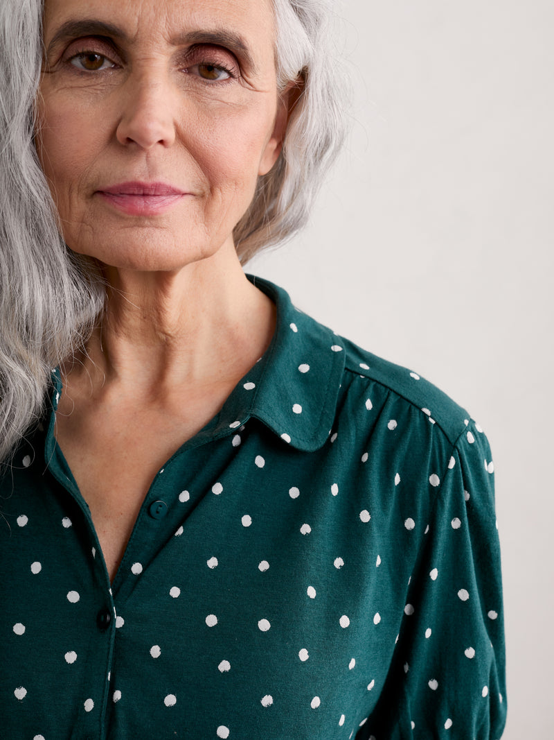 Seasalt Embrace Shirt. A green shirt with white polka dots, featuring a slightly fitted cut, collar, gathered short sleeves and button fastenings.