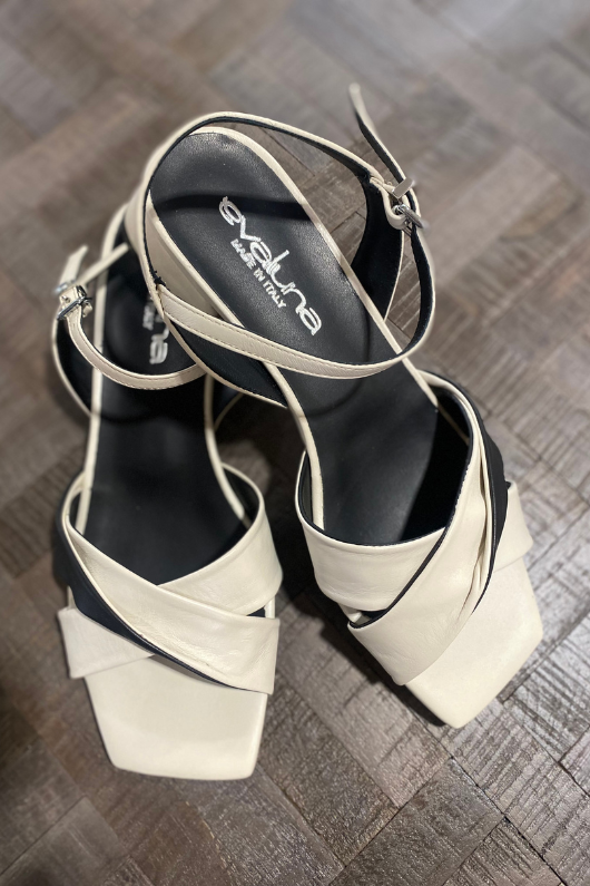 An image of the Evaluna Adel Flat Strappy Sandals in the colour Milk Nero - a blend of cream and black.