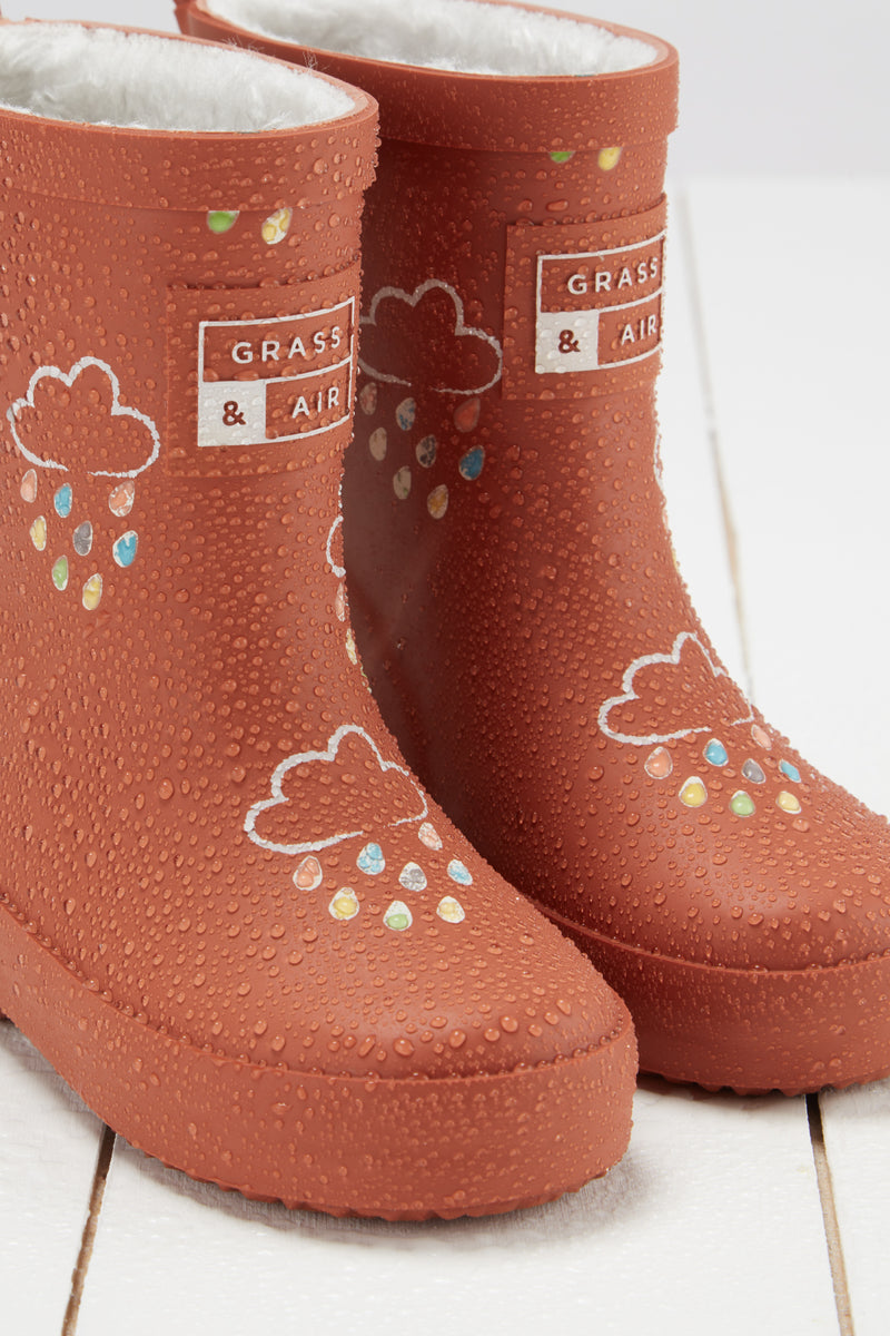 An image of the Grass & Air Colour Changing Kids Wellies in Burnt Orange.