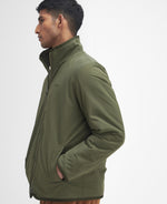 An image of the Barbour Reversible Fleece in Fern.