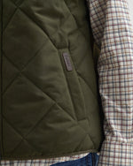 An image of the Barbour Hybrid Gilet in Olive.