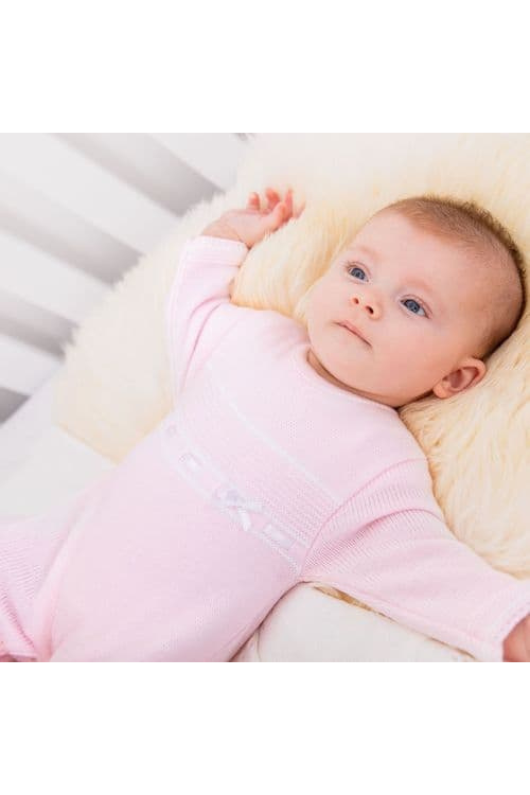 An image of the Dandelion Knitted Onesie in Pink.