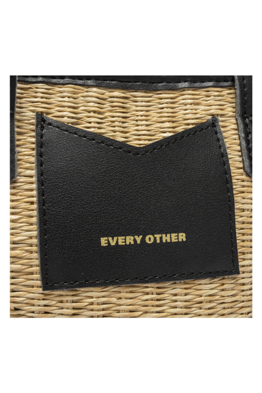 Every Other Straw Rattan Grab Bag. A small raffia bag with black faux leather details, top handles, crossbody strap, and fully lined interior with zip pocket.