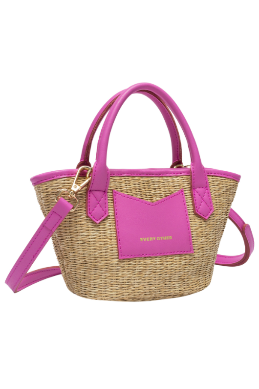 Every Other Straw Rattan Grab Bag. A small raffia bag with pink faux leather details, top handles, crossbody strap, and fully lined interior with zip pocket.