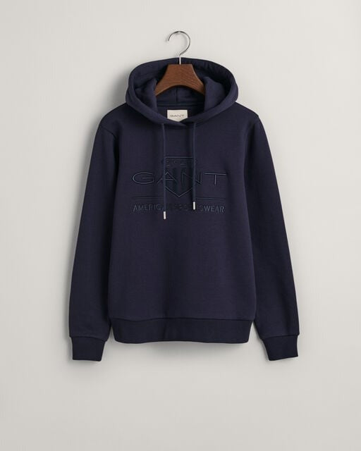 An image of the Gant Tonal Archive Shield Hoodie in Evening Blue.