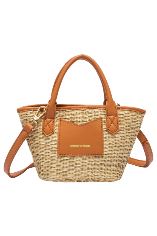 Every Other Straw Rattan Grab Bag. A small raffia bag with tan faux leather details, top handles, crossbody strap, and fully lined interior with zip pocket.