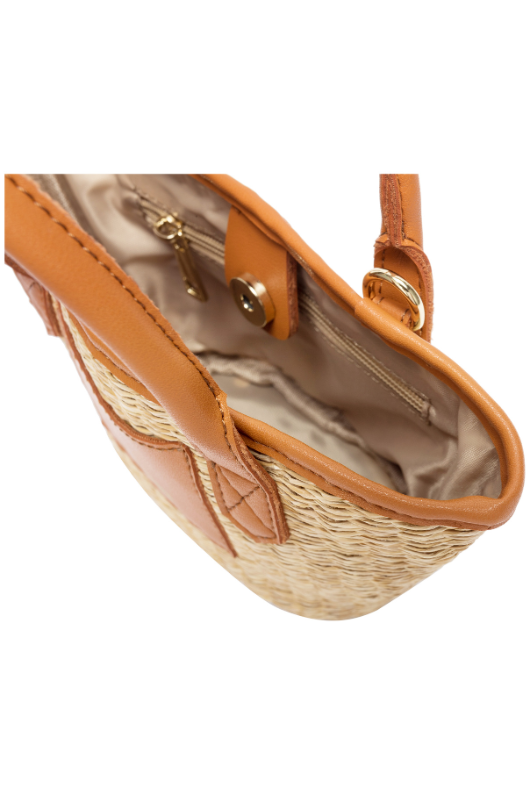 Every Other Straw Rattan Grab Bag. A small raffia bag with tan faux leather details, top handles, crossbody strap, and fully lined interior with zip pocket.