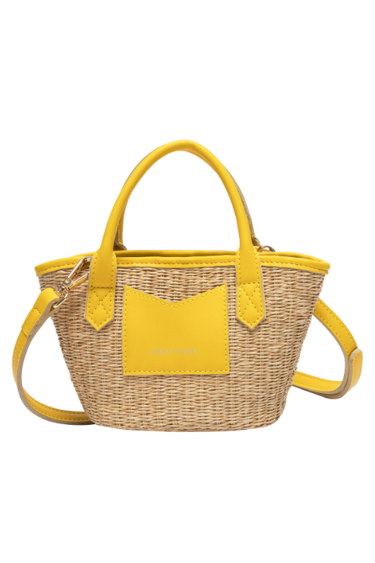 Every Other Straw Rattan Grab Bag. A small raffia bag with yellow faux leather details, top handles, crossbody strap, and fully lined interior with zip pocket.